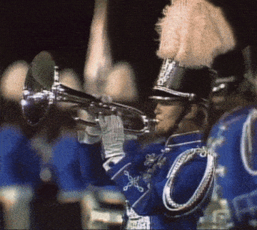 a man in a marching band uniform plays a trumpet