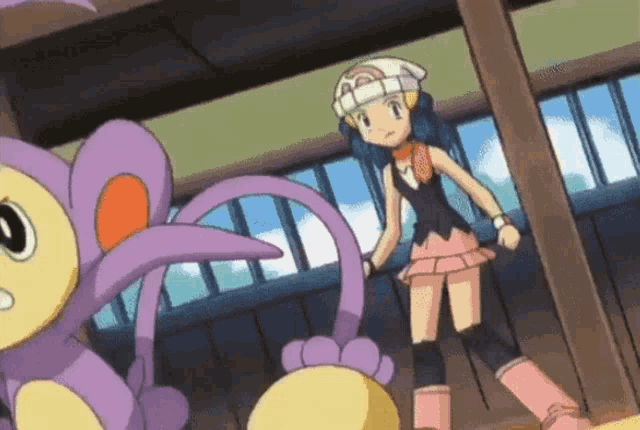a girl standing next to a purple and yellow animal