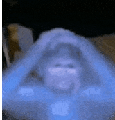 a blurry picture of a person 's face with a blue light coming out of it .