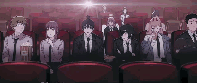 a group of people are sitting in a theater watching a movie .