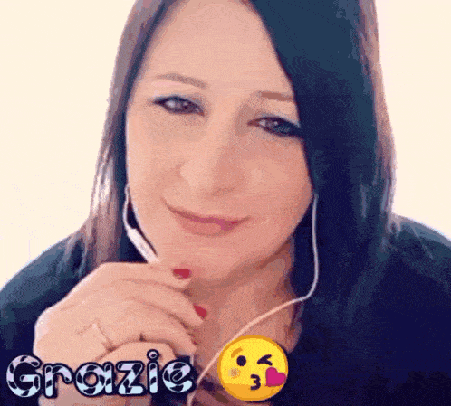 a woman wearing headphones and a smiley face with the word grazie written on it