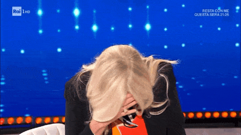a woman covering her face in front of a rai 1 hd sign