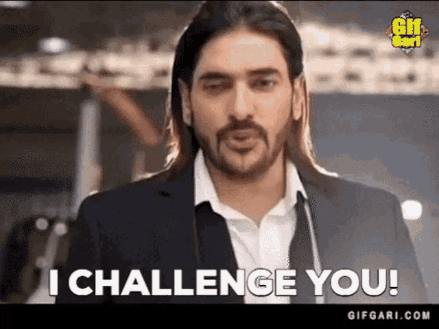 a man with long hair and a beard says " i challenge you "