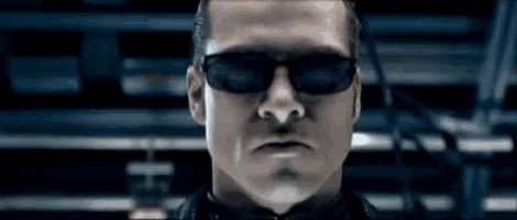 a man wearing sunglasses is looking at the camera .