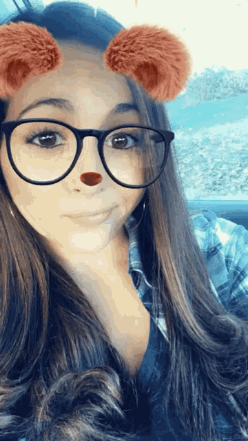 a woman wearing glasses and a bear nose filter
