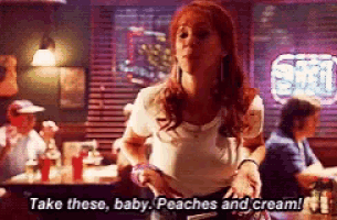 a woman in a restaurant says take these baby peaches and cream !