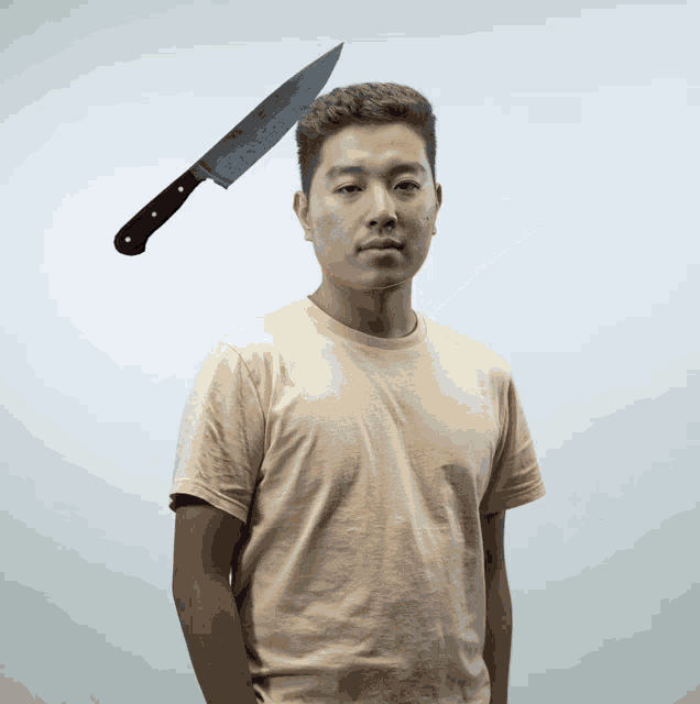 a man with a knife on his head looks at the camera