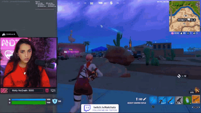a woman is playing a video game with a purple background