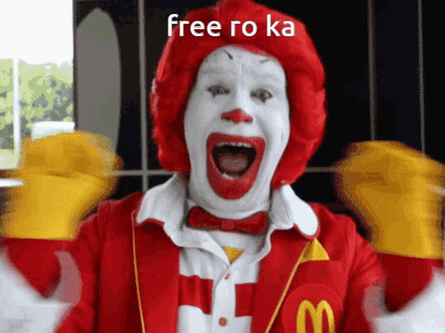 a mcdonald 's clown is screaming with the words free ro ka written above him