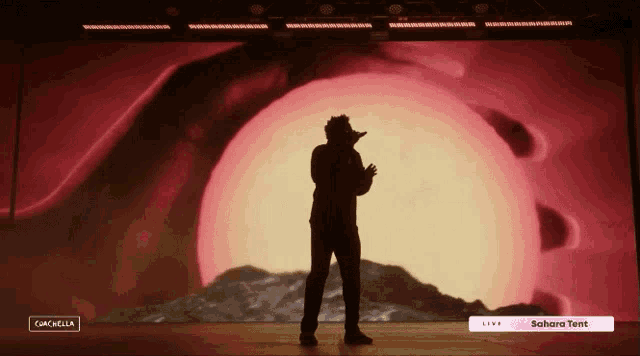 a man stands in front of a sahara tent