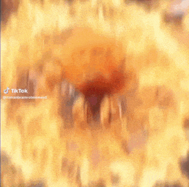 a close up of a person 's face with a blurred background and a flame coming out of it .