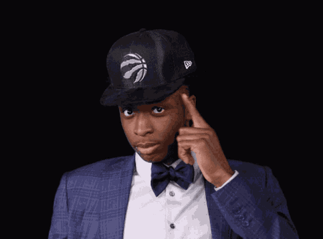 a man wearing a hat with a basketball on it and a bow tie