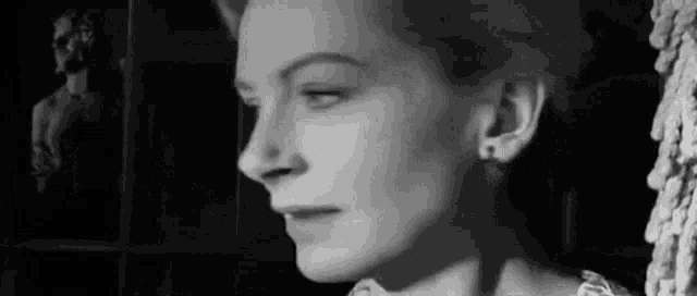 a close up of a woman 's face in a black and white photo .