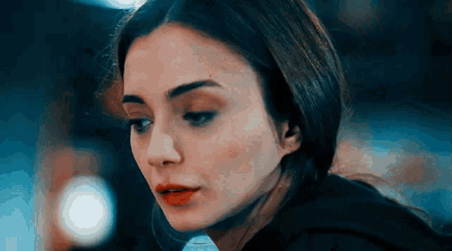 a close up of a woman 's face with a serious look on her face