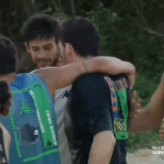 a woman hugging a man wearing a green shirt that says survivor on it
