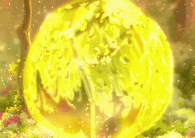 a woman in a green dress is standing in front of a large yellow sphere .