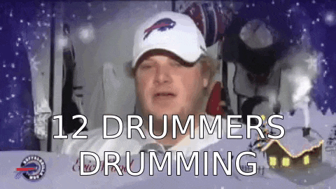 a man wearing a buffalo bills hat is playing drums