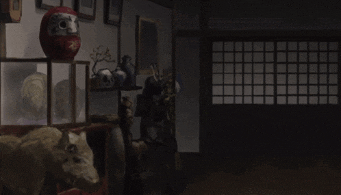 a room filled with a lot of objects including a statue of a samurai