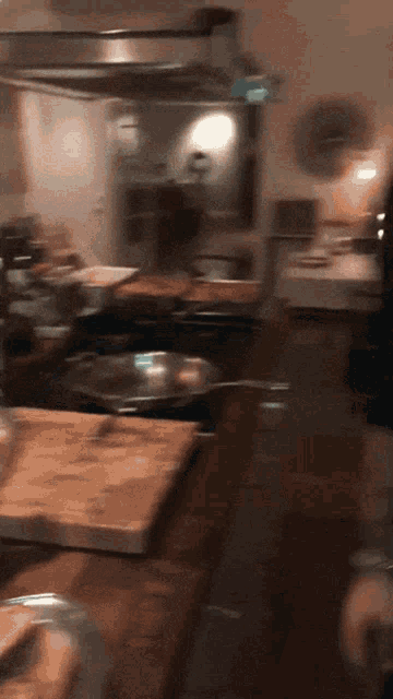 a kitchen with a wooden cutting board and a pan
