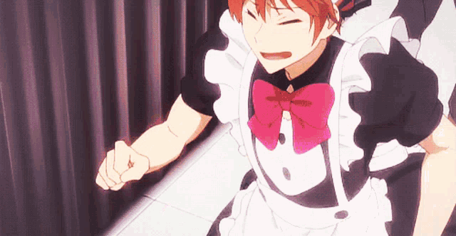 a man in a maid outfit with a pink bow on his neck
