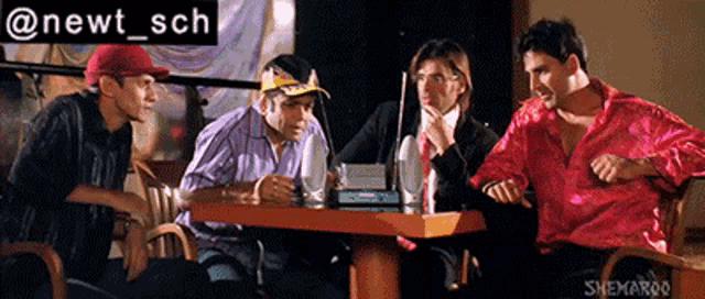 a group of people sitting around a table with a sign that says newt sch