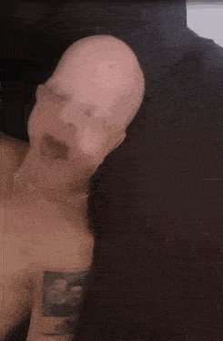 a man without a shirt has a tattoo on his arm that says ' 88 '
