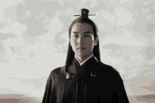 a man wearing a black cape and a black hat