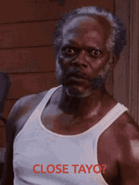 a man in a white tank top with the words close tayo written in red