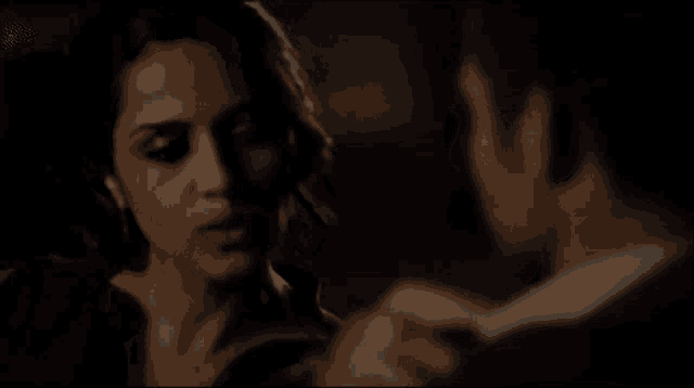 a man and a woman are looking at each other in the dark