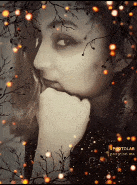 a woman with her hand on her chin is surrounded by branches and lights with the words photolab.me at the bottom