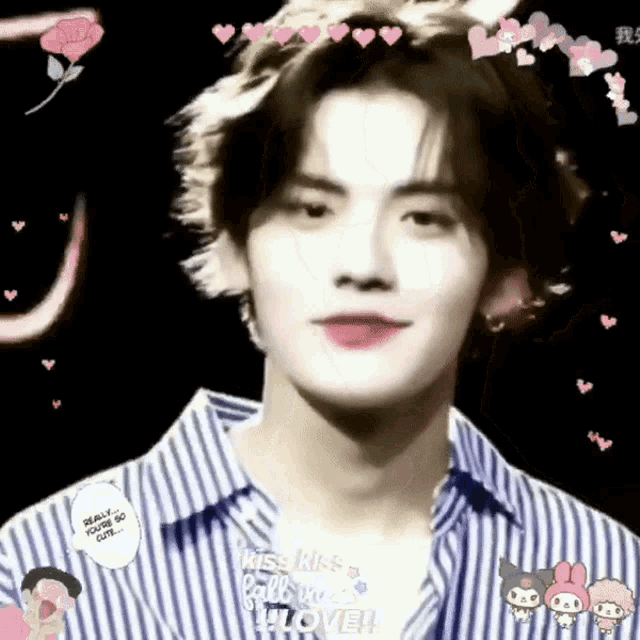 a young man in a striped shirt is looking at the camera with hearts around his face .