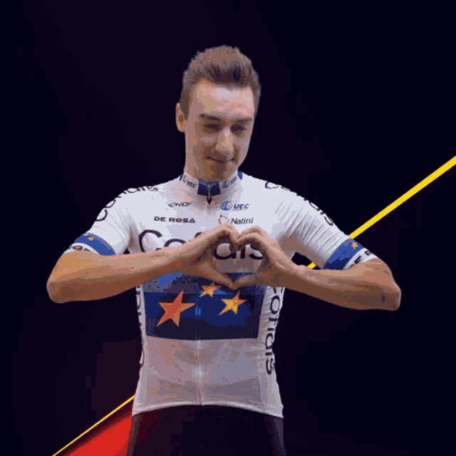 a man wearing a white cofidis jersey making a heart shape with his hands