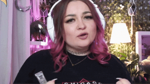 a woman with pink hair is wearing headphones and a chicago t-shirt