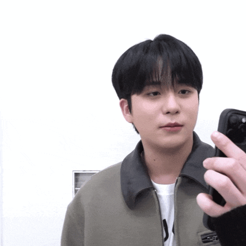 a man taking a picture of himself with a cell phone