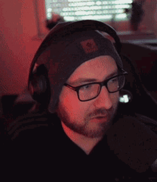 a man wearing headphones and a beanie has a patch on his hat that says ' army '