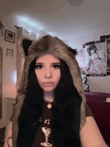 a girl wearing a furry hat and a t-shirt that says l.f.t.