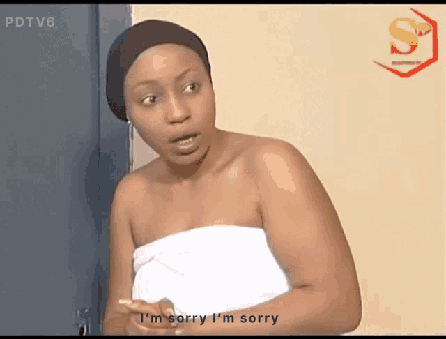 a woman is wrapped in a towel and says i 'm sorry i 'm sorry