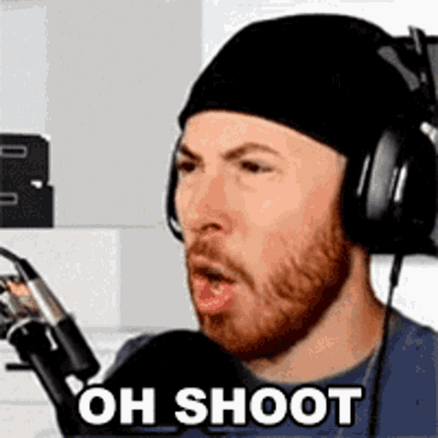 a man wearing headphones is talking into a microphone .
