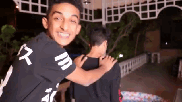 two young men are hugging each other and one of them has the number 7 on his shirt