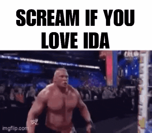 a man is screaming in a wrestling ring while a crowd watches .
