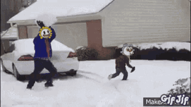 a man and a little girl are playing in the snow .