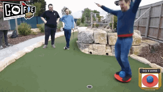 a group of men are playing a game of golf with a sign above them that says hot five