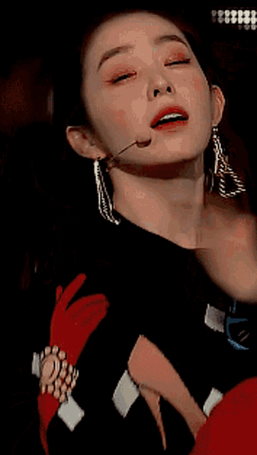 a close up of a woman 's face with her eyes closed and her mouth open