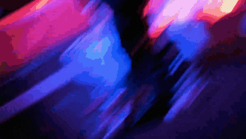 a blurry picture of a blue and pink light
