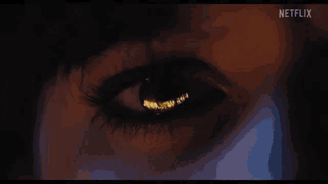 a close up of a person 's eye with a netflix logo in the corner