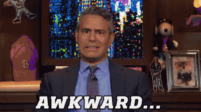 a man in a suit and tie says awkward in front of a display