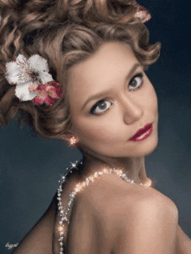 a woman with a flower in her hair and a necklace on her neck