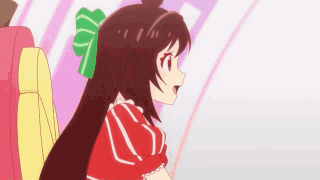 a girl with long hair and a green bow on her head