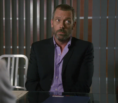 a man in a suit is sitting at a table