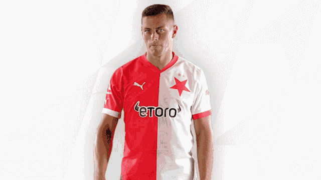 a man wearing a red and white jersey with etoro on it